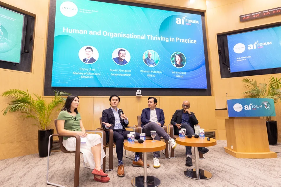 Speaking at the panel were (from left) Insead Thrive Lab’s academic director and panel moderator Winnie Jiang; the manpower ministry’s deputy secretary for workforce Kenny Tan, Google DeepMind’s head of organisational AI research Martin Gonzalez, and Insead’s professor of strategy Phanish Puranam.