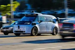 A Waymo Ojai autonomous vehicle, a China-made EV manufactured by Zeekr, on the road in Los Angeles, California.